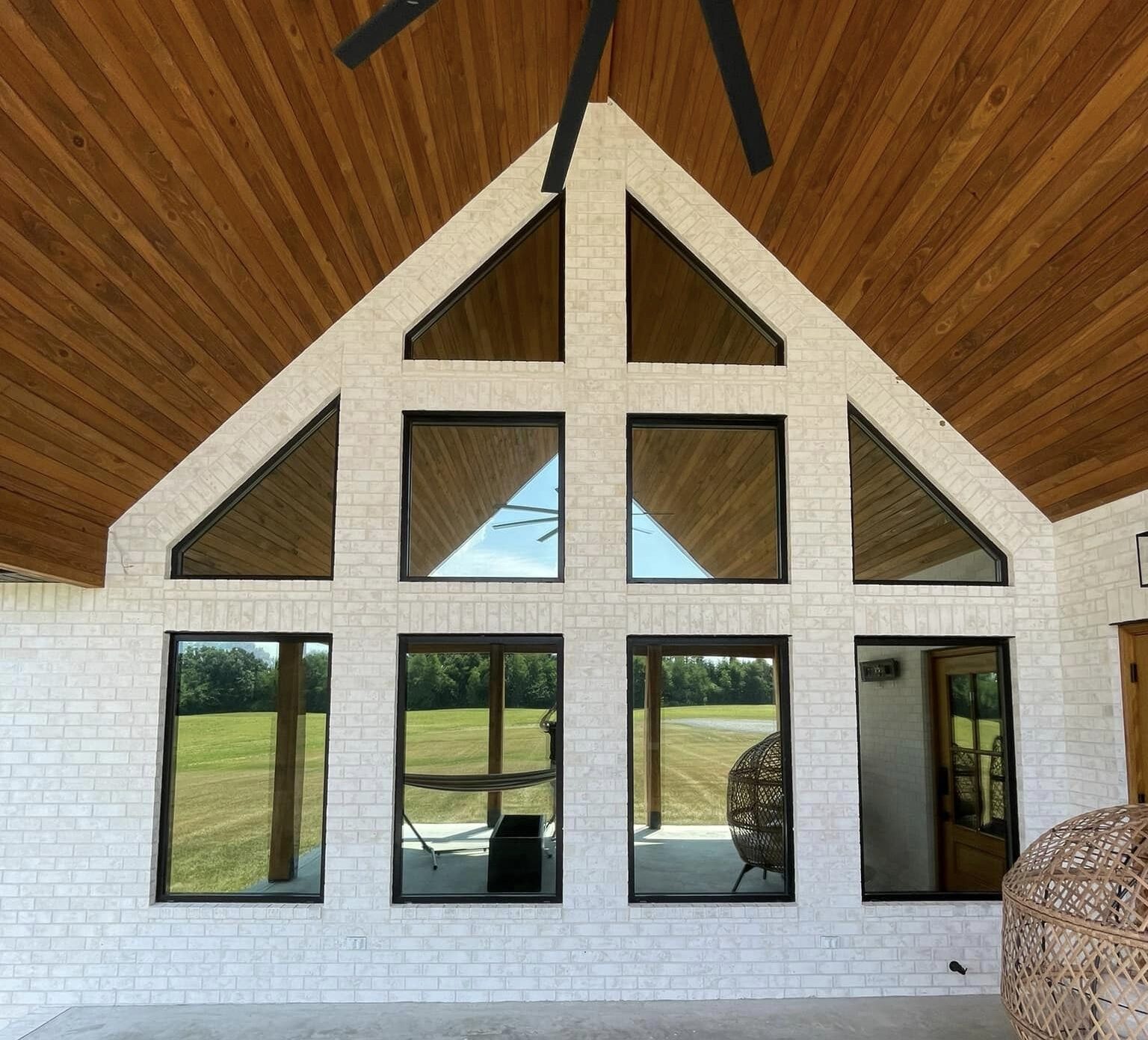 A-frame house with tinted privacy windows.