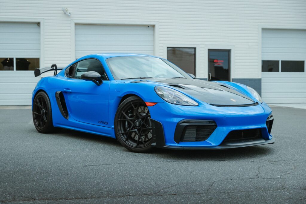 A blue and back porsche at Sun Stoppers