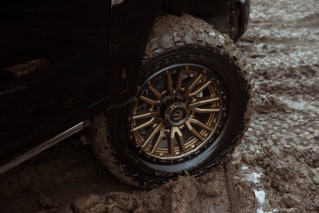 gold fuel rims on a muddy truck tire